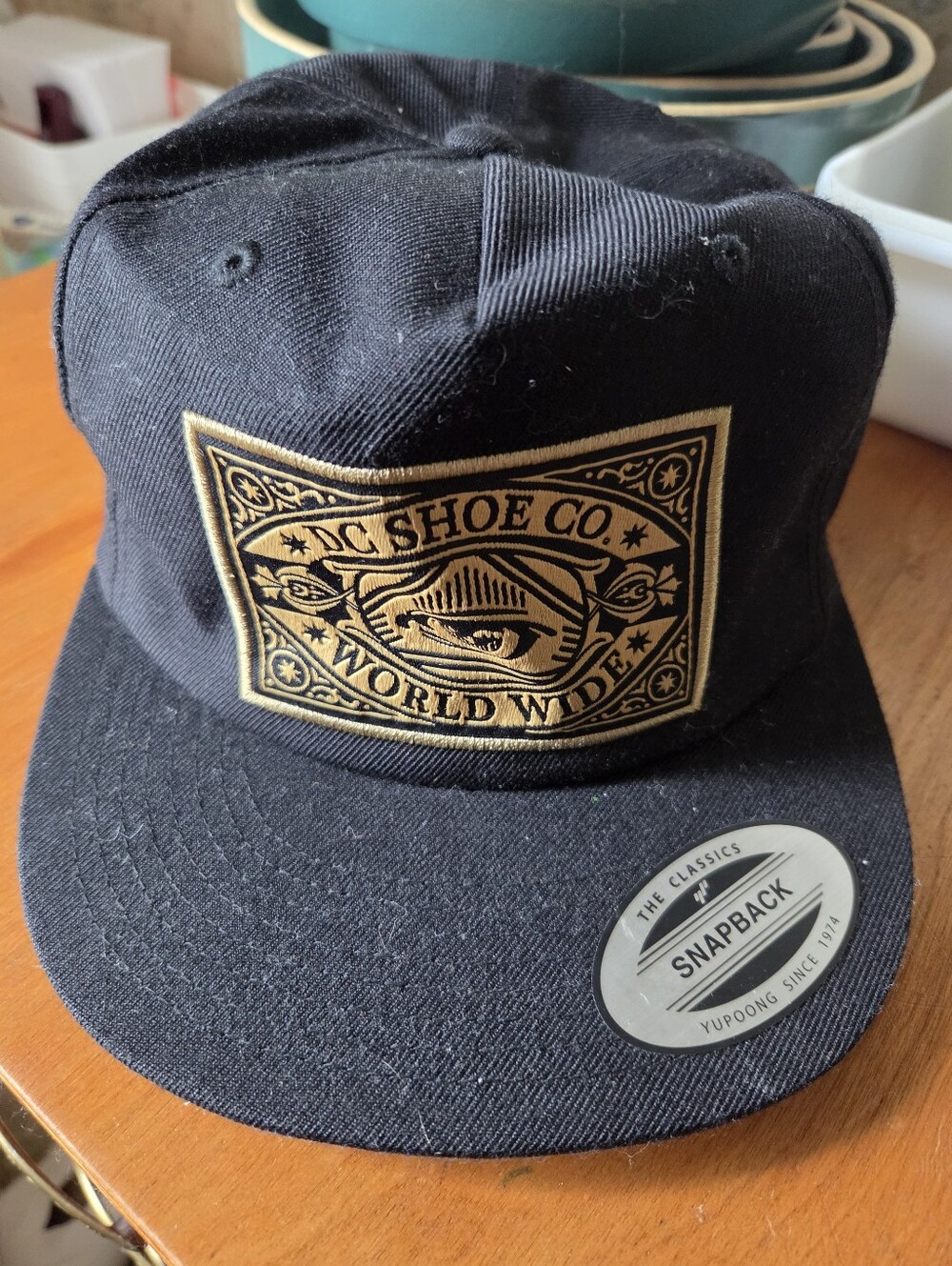 DC Shoe Co. World Wide Black Snapback Hat with Gold Patch, One Size Fits All